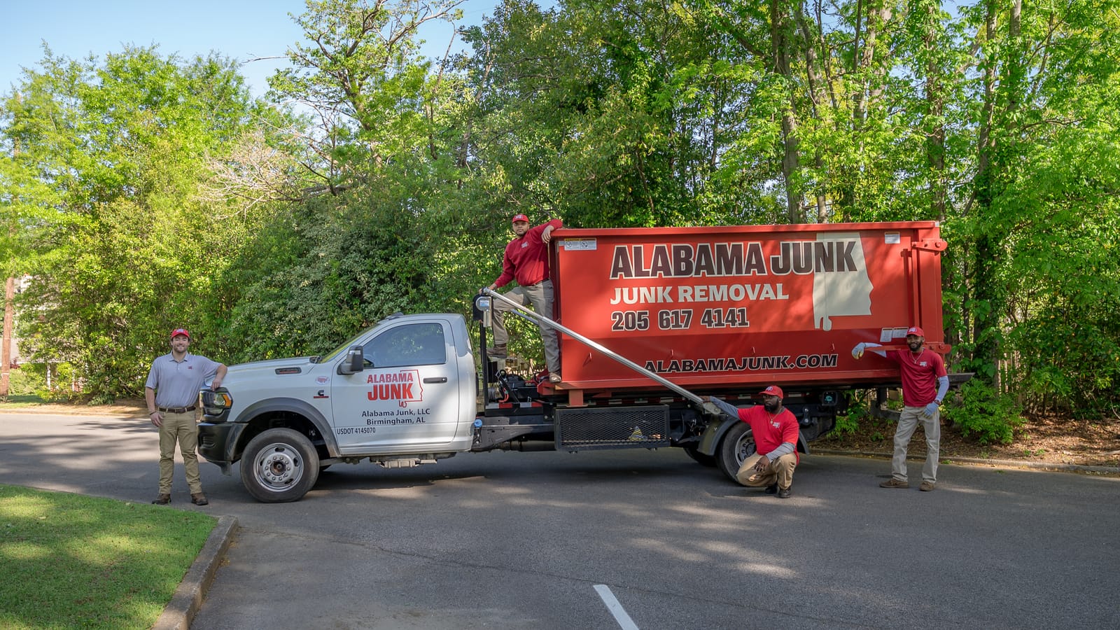 Alabama Junk crew and the hook-lift truck with the red container on a job